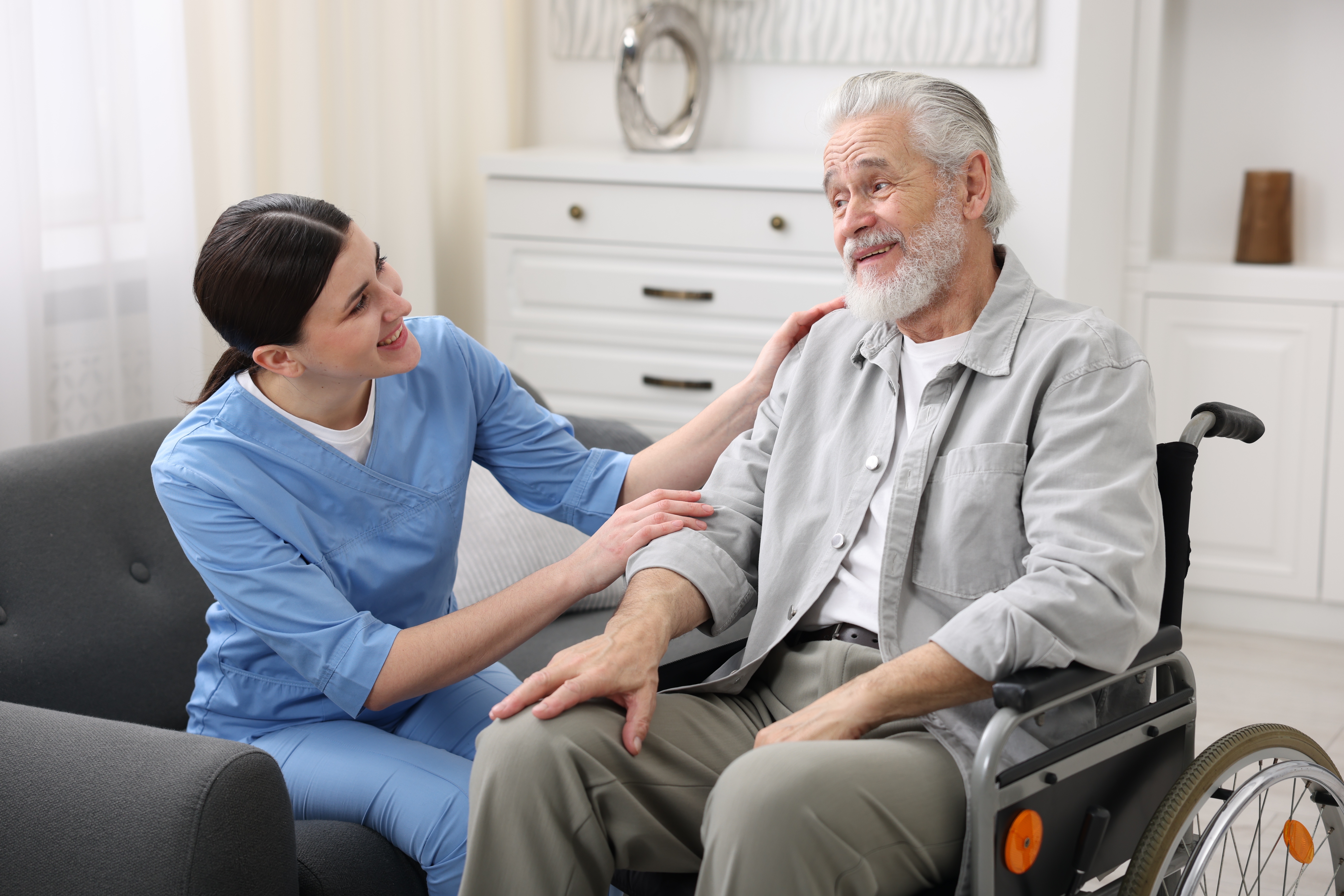Care worker supporting senior man