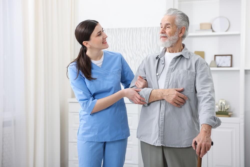 Caregiver helping senior man in Lethbridge