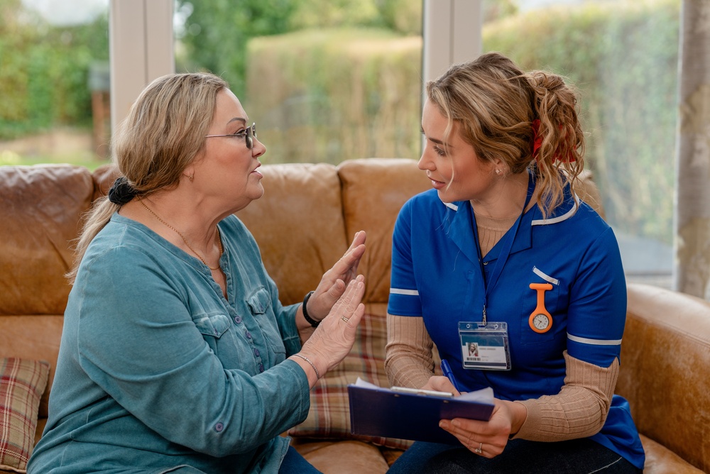 Caregiver talks with senior woman