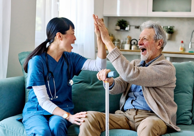 Nurse caregiver and senior man with high five gesture
