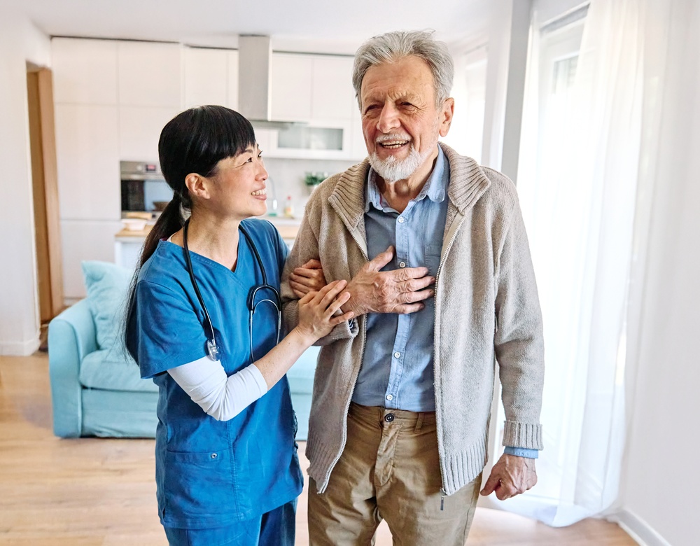 Nurse caregiver helping senior man
