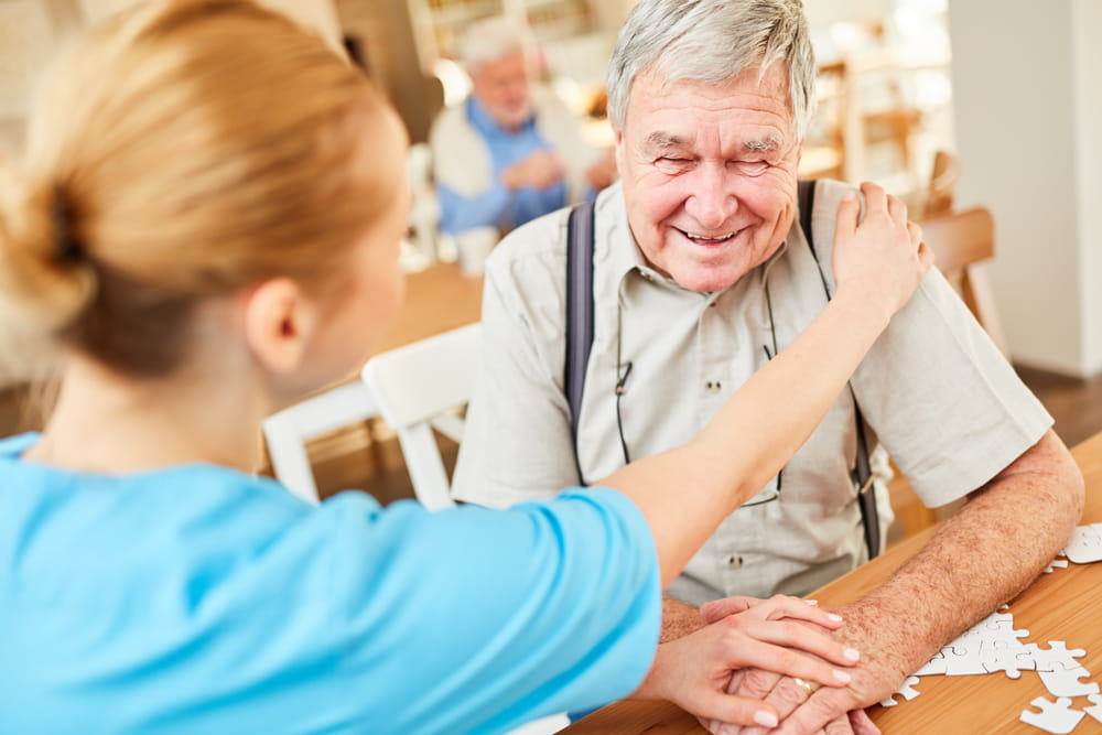 Nurse consoles a senior with dementia